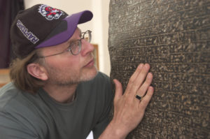 Filmmaker Simcha Jacobovici examining El Arish stele